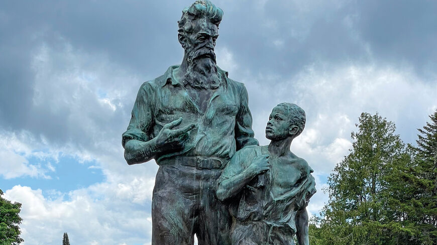 Bronze statue of John Brown and a young boy, representing 1850s America — Road to the Civil War, standing in an outdoor park.