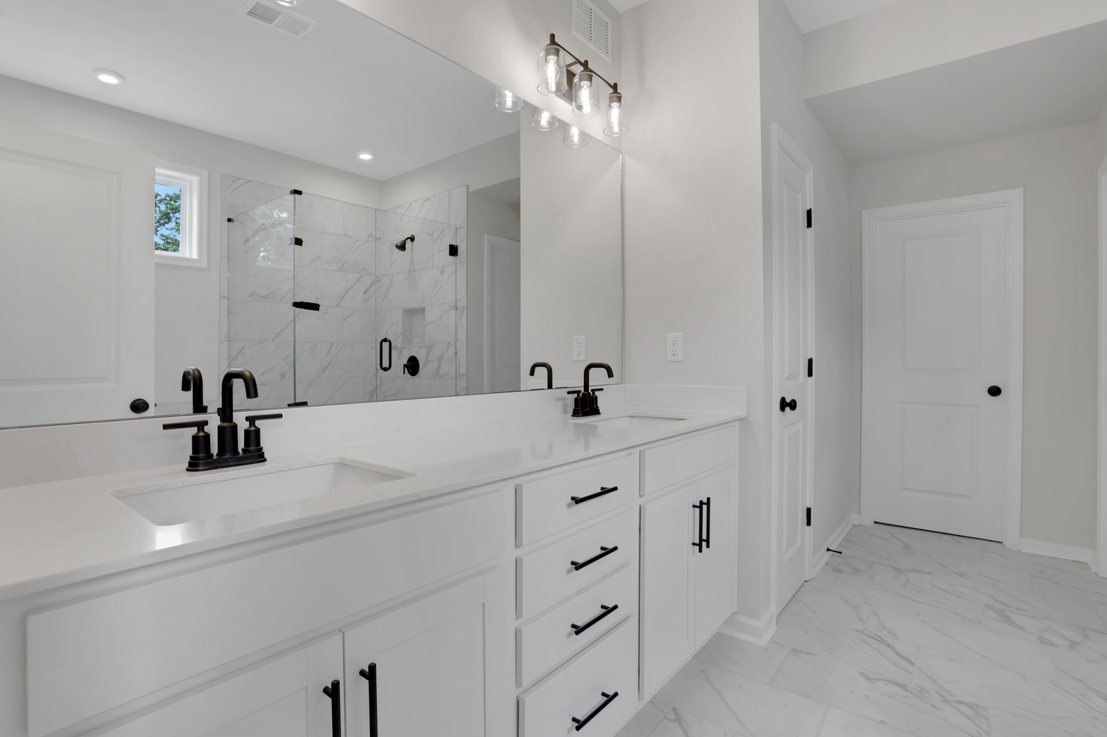 secondary bathroom with white cabinets and tile flooring