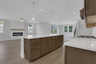 kitchen with wood-finish cabinets and quartz counters