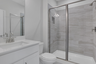 secondary bathroom with white cabinets and tile flooring