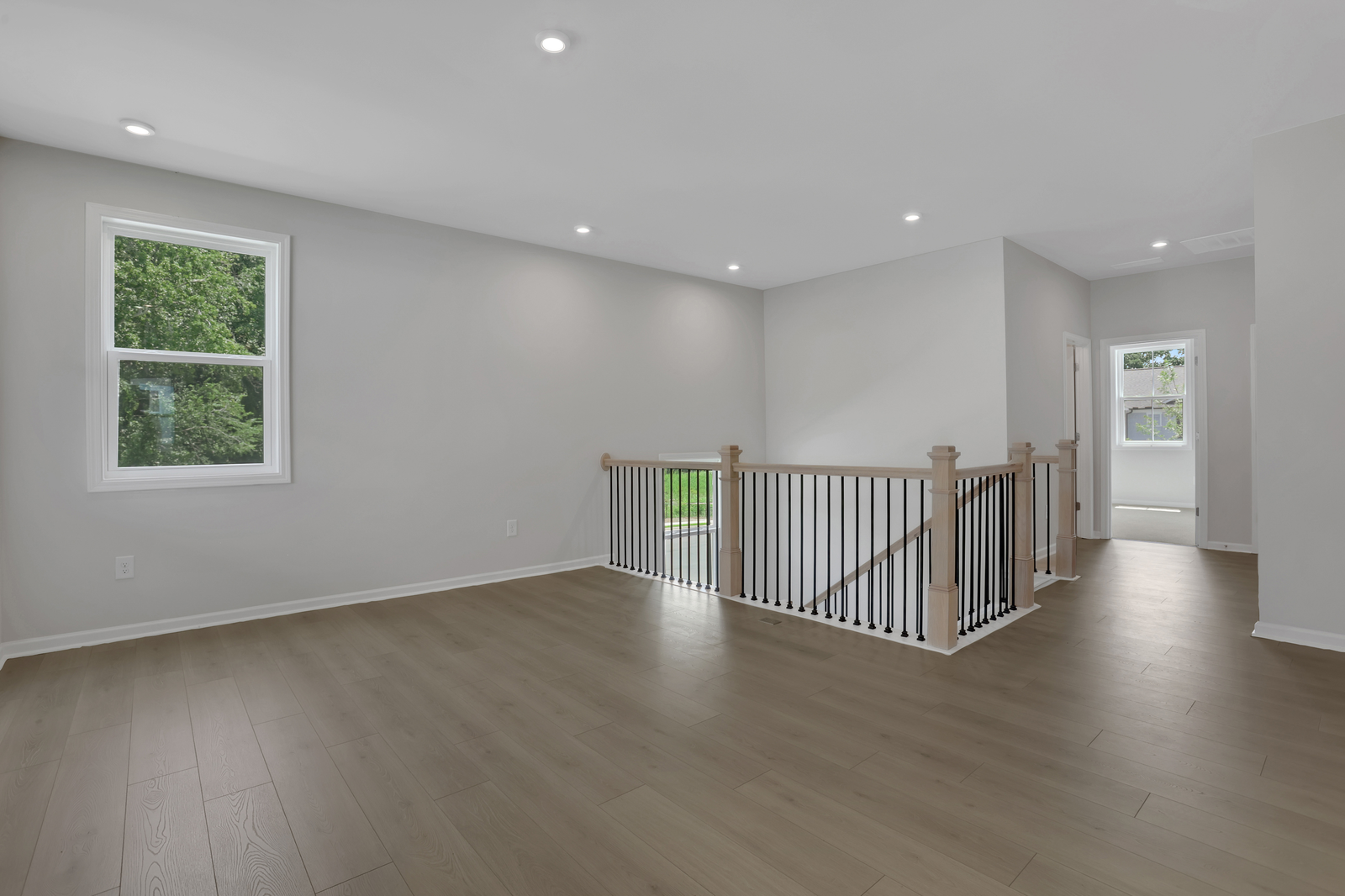 loft with hard surface flooring and windows