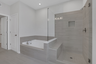 primary bathroom with separate shower and tub