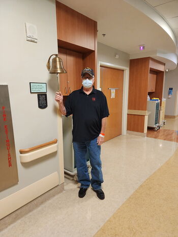 Lloyd Hyatt rings the bell at Moffitt after the completion of his treatment.