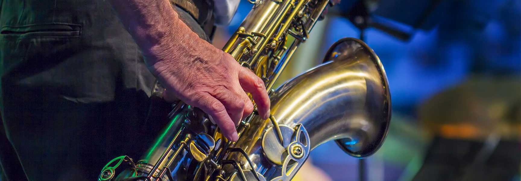 A close-up of a musician playing the saxophone at a jazz festival in California.