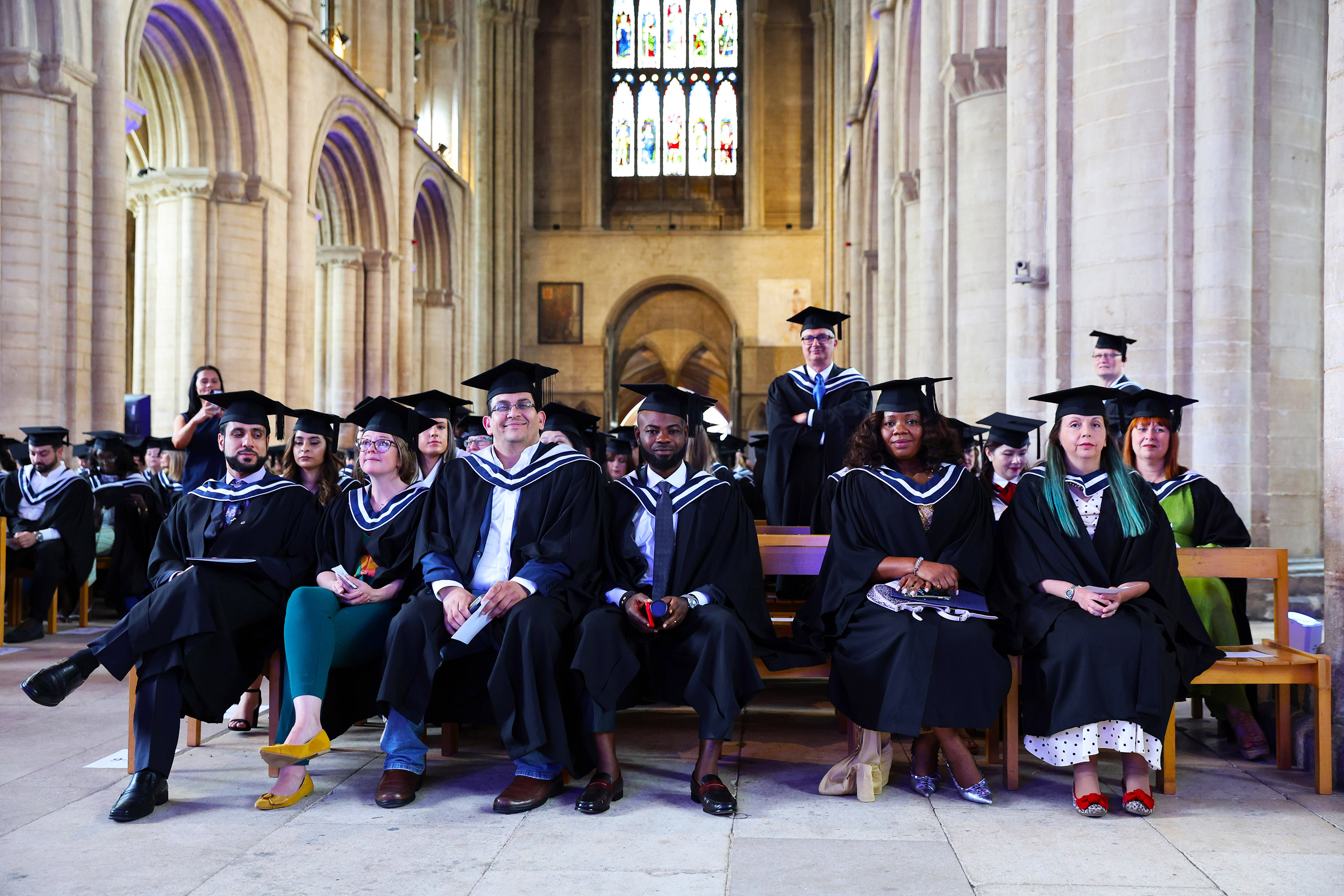 A row of graduates seated together in the church during the ceremony