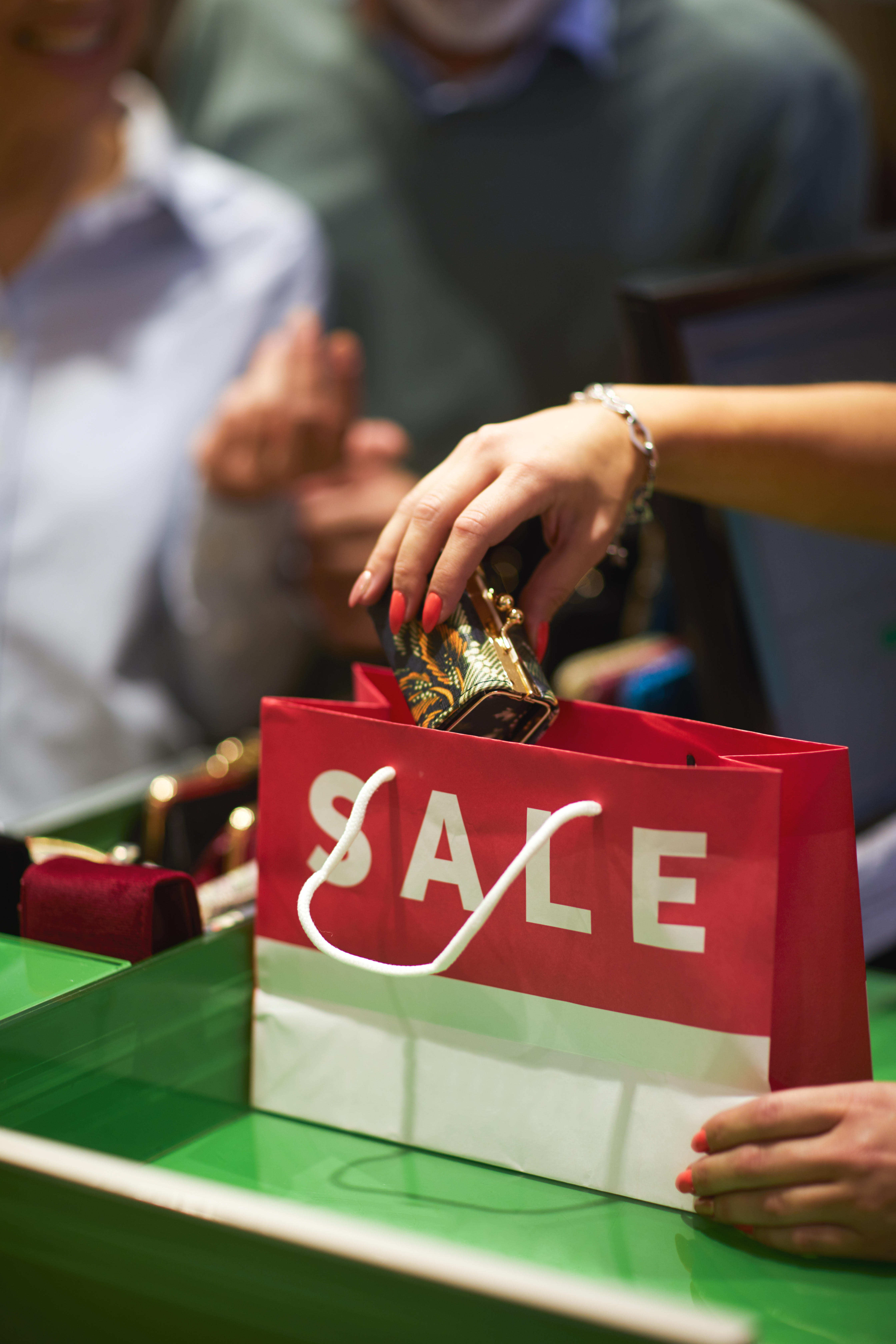 Consumer putting an item in a sale bag