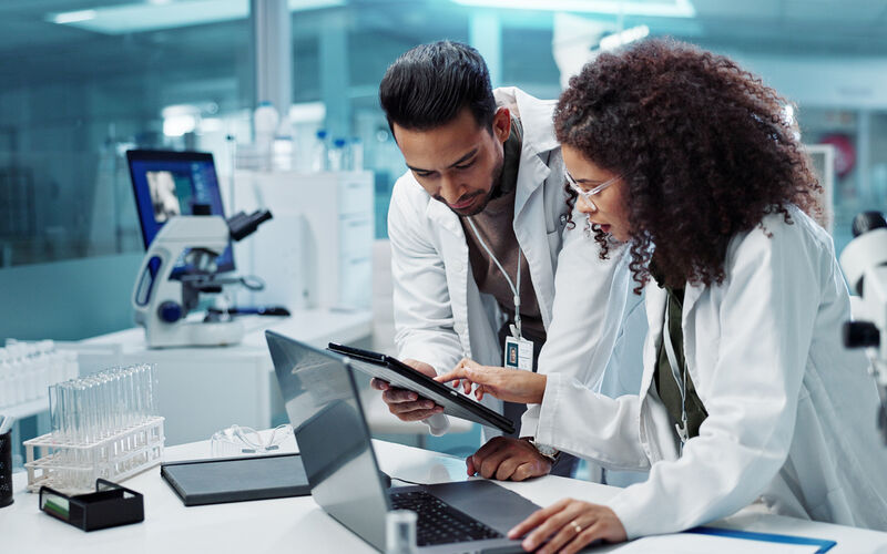 Researchers in a lab look over data