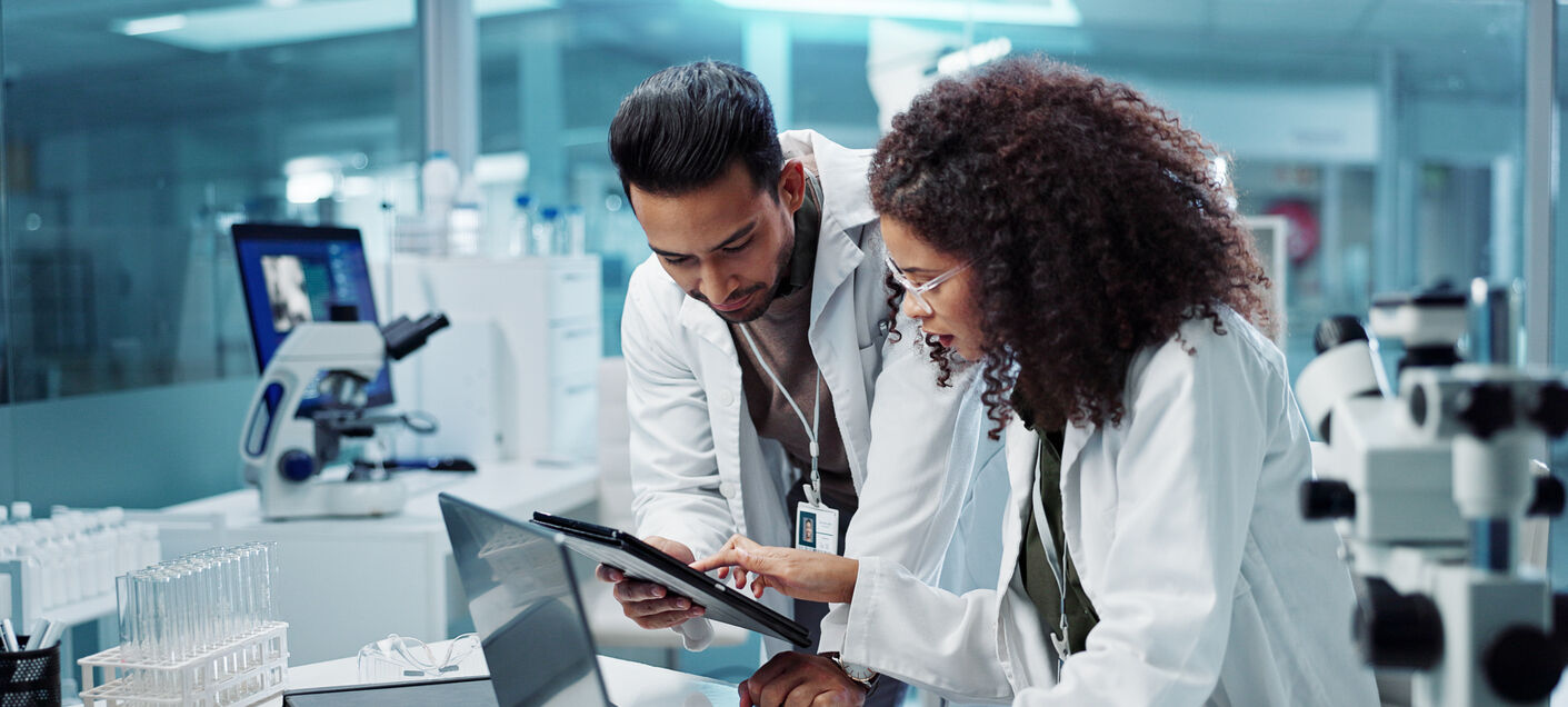 Researchers in a lab look over data