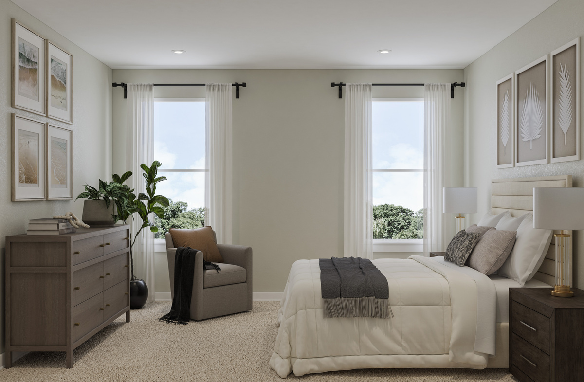 primary bedroom with a king bed and two windows 