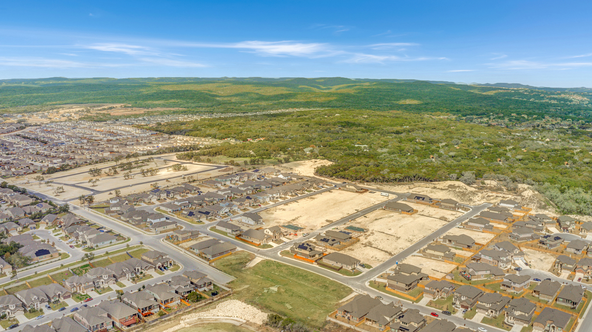 aerial view of the community with dirt & trees