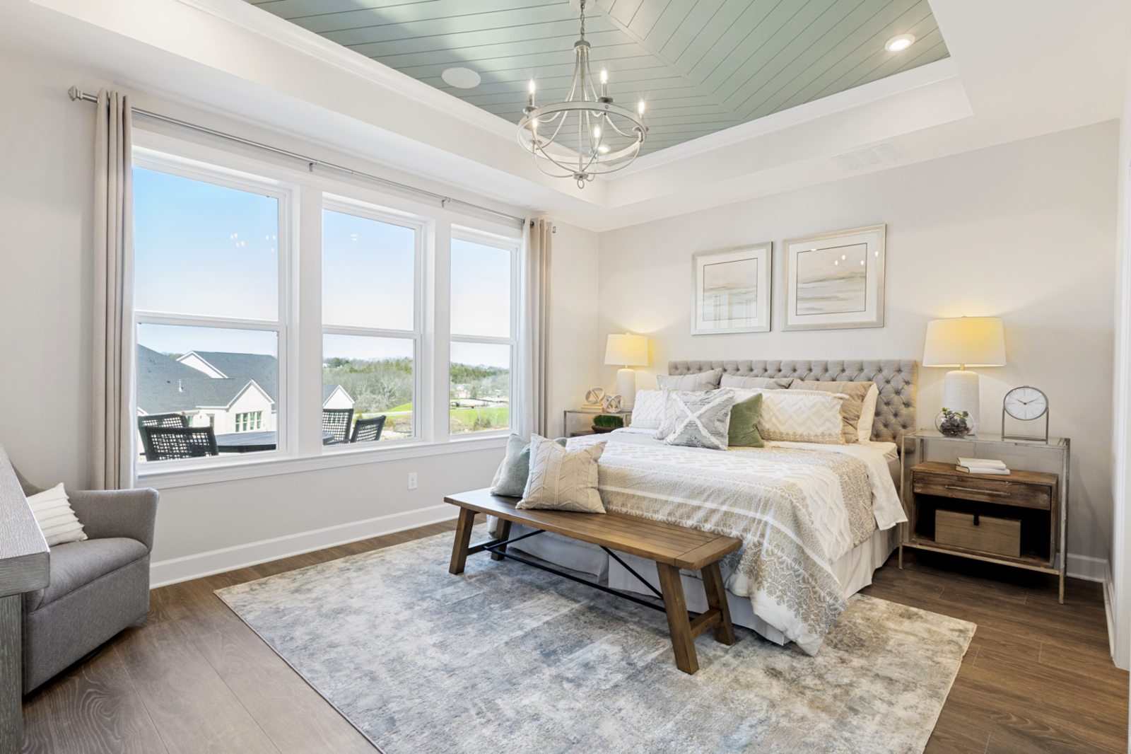primary bedroom with a tray ceiling