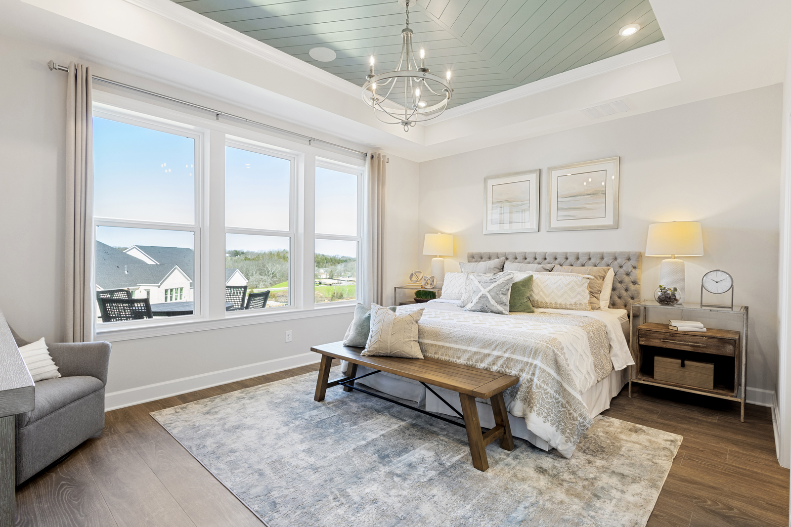 primary bedroom with bed, nightstands, and windows