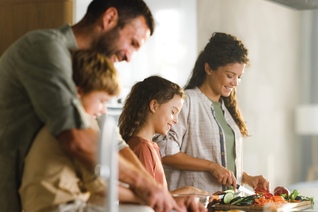 Happy family preparing healthy meal in the kitchen.