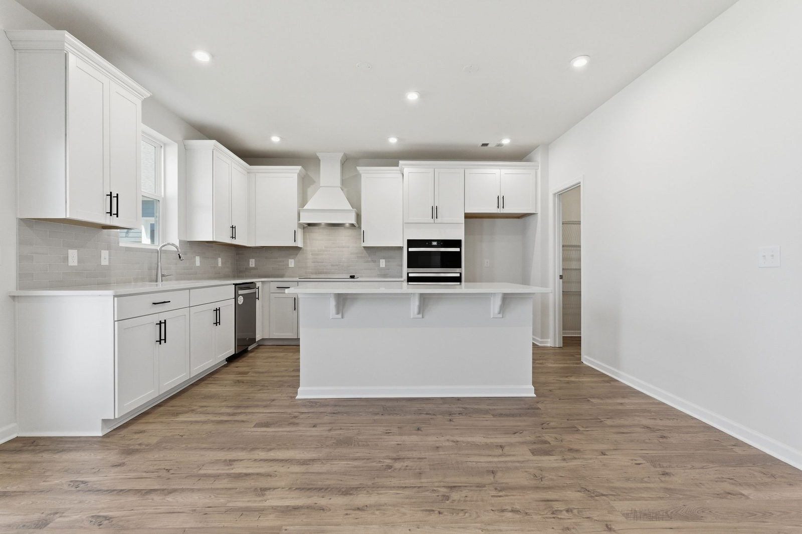 kitchen with white cabinets and large island