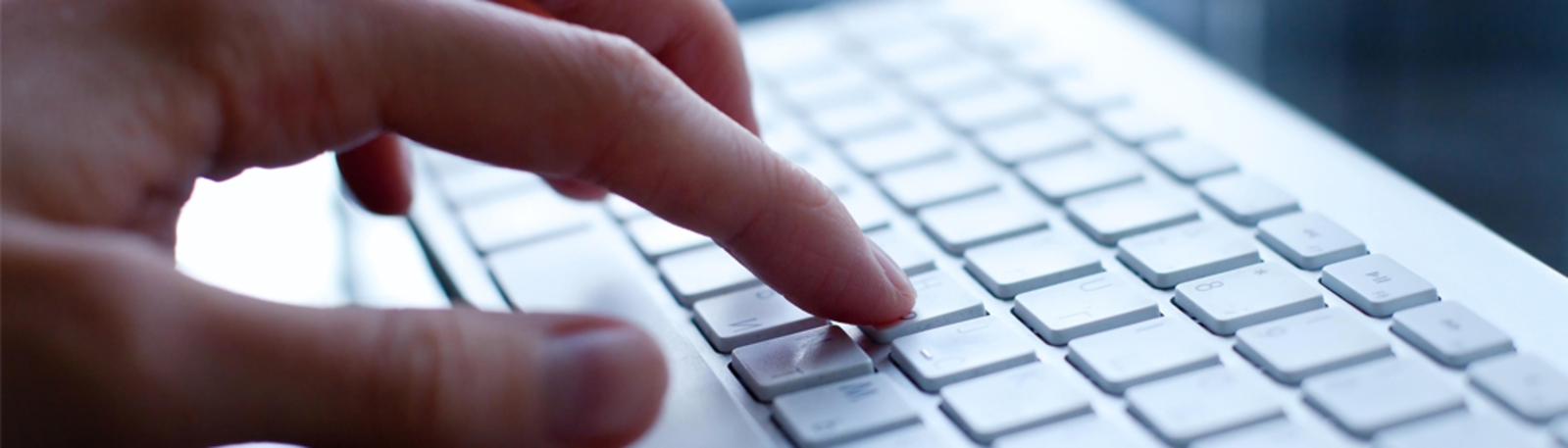 Close up of hand on keyboard.