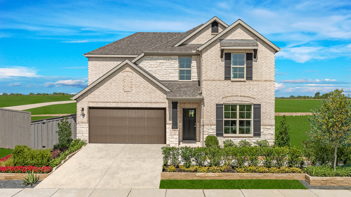 stone and brick home exterior with a small tree