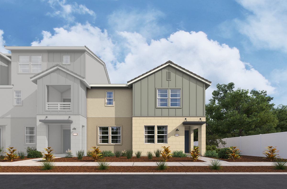 exterior of two-story townhome with large windows and desert landscaping