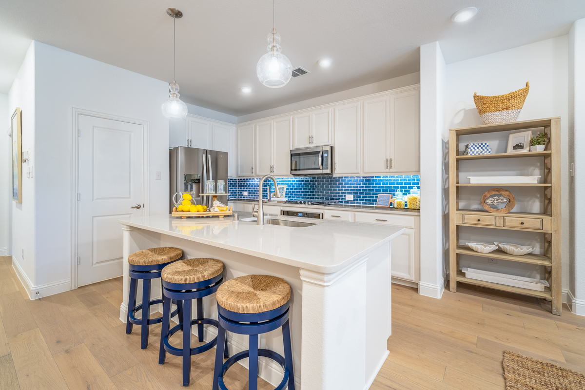 open kitchen with large island and white cabinets