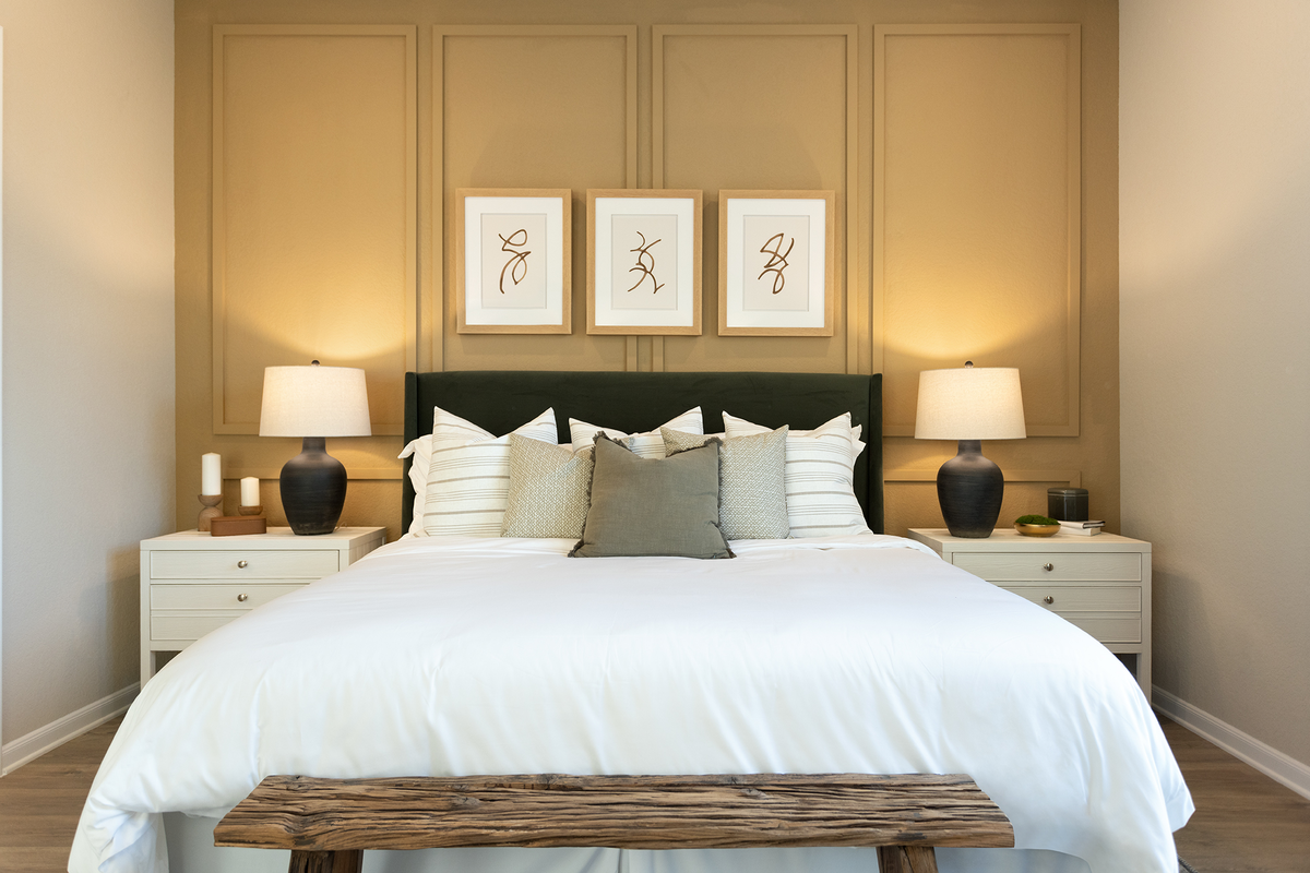 bedroom with brown flooring, windows & ceiling fan