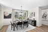 dining table with chairs and carpet and hardwood floors underneath, entrance to deck