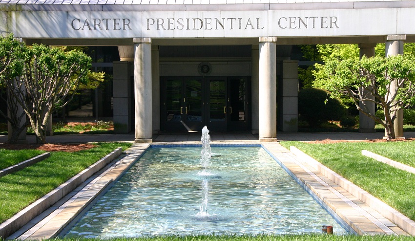 A fountain bubbles in a pool outside of the Carter Presidential Center