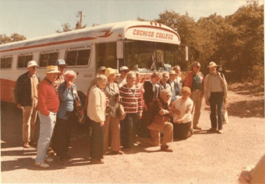 Road Scholars pose in front of a bus from Cochise College