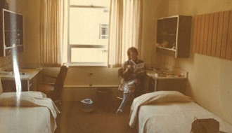 A Road Scholar sits in a dorm room reading