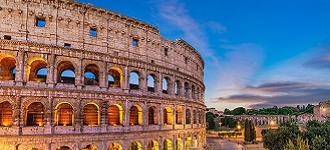 A view of the Colosseum lit up at dusk