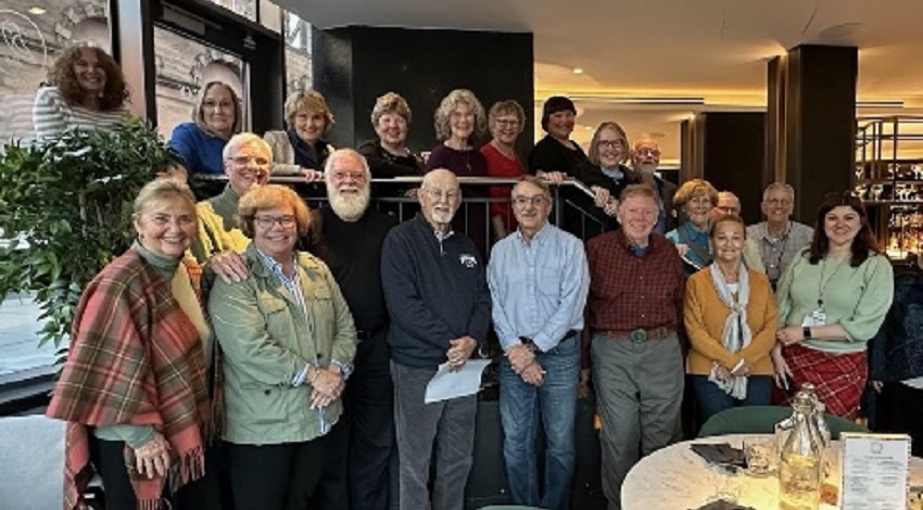 A group of Road Scholars smiles in a restaurant