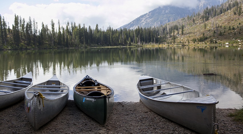 Canoes on the shoreline of a mountain lake
