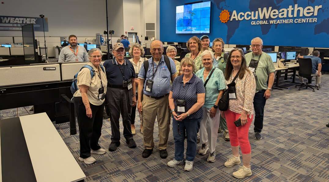 A group photo of George's Road Scholar group at the AccuWeather Global Weather Center