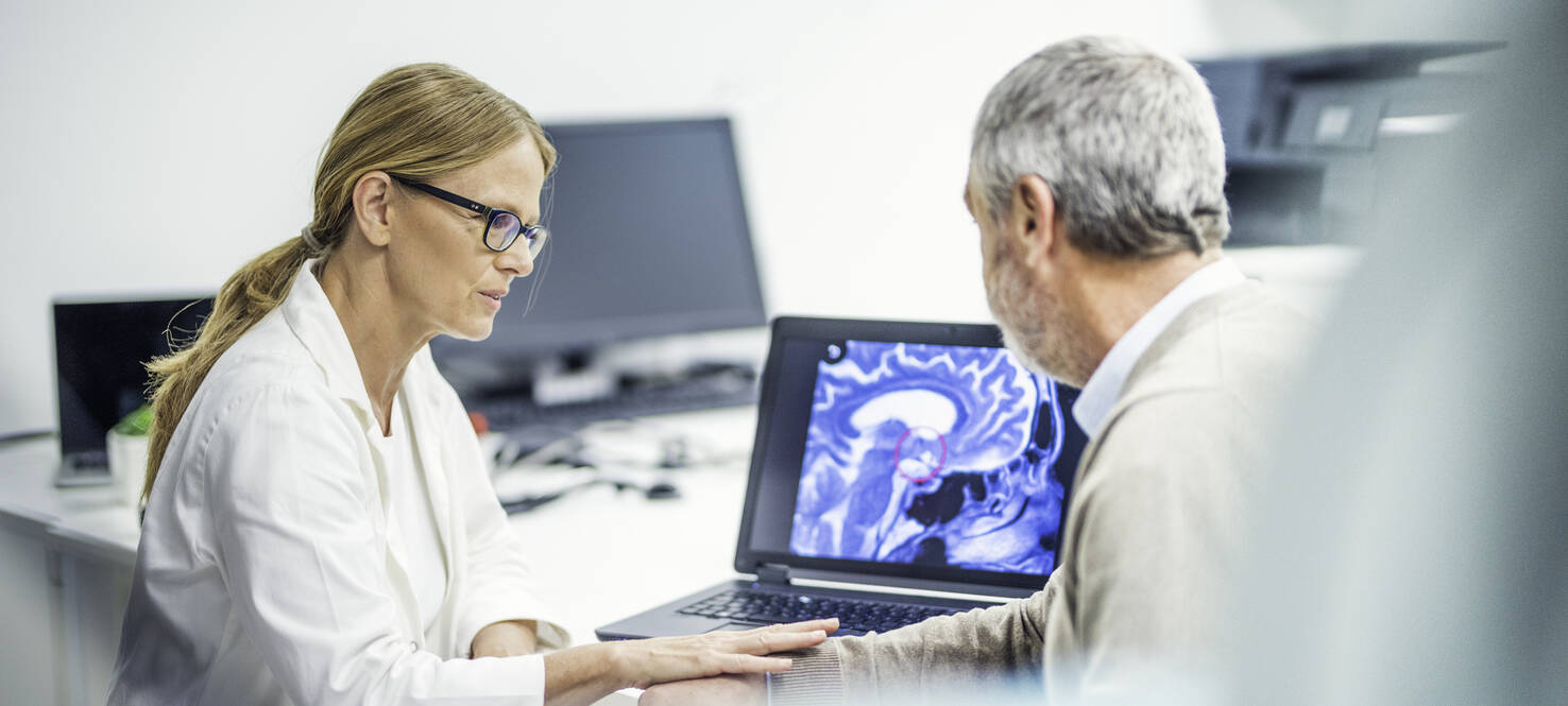 doctor reviews MRI scan with patient