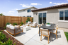 backyard with concrete patio, outdoor conversation & dining furniture, and grass