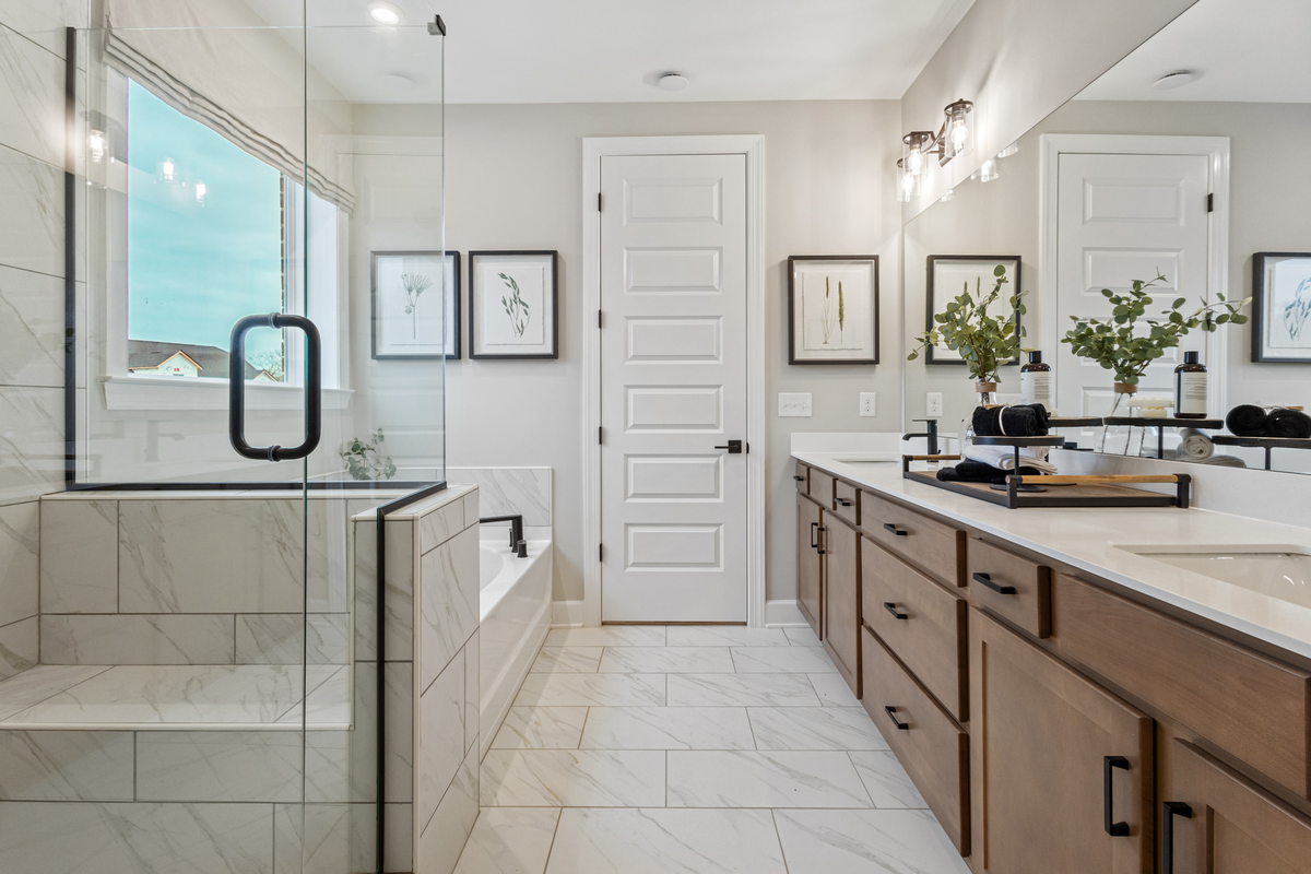 marble bathroom with shower, bathtub, and vanity