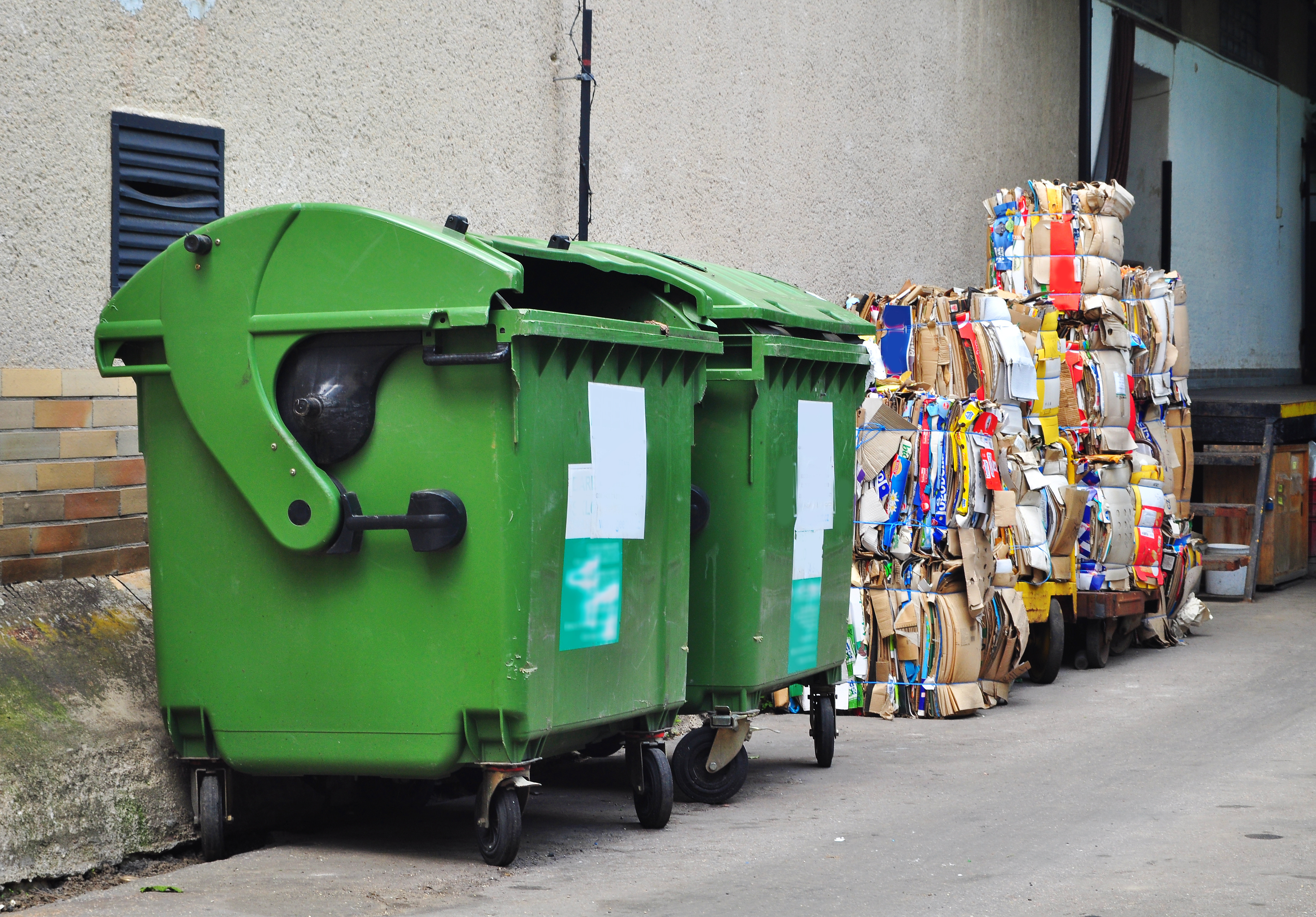 Waste on the street includinge large bins, paper and cardboard bailed waste