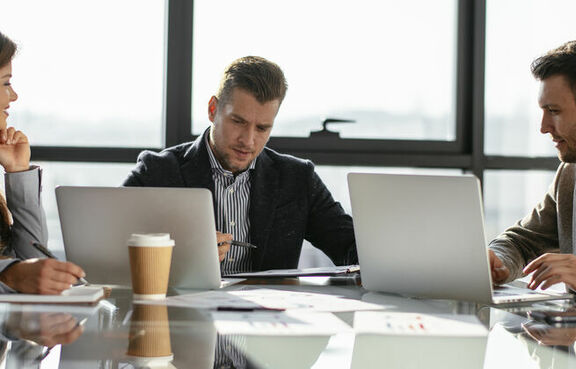 Coworkers sitting at a meeting table 