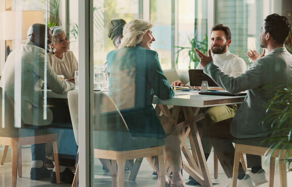 Business professionals meeting in glass office