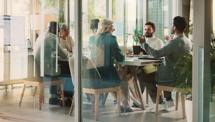 Business professionals meeting in glass office