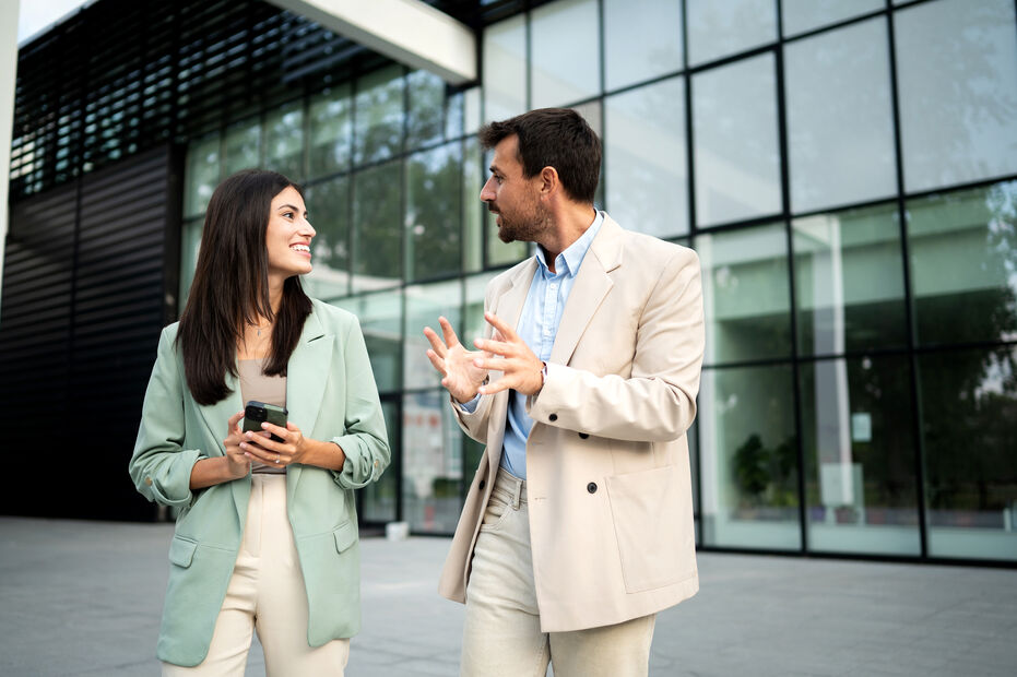 Man and woman talking outside of office building