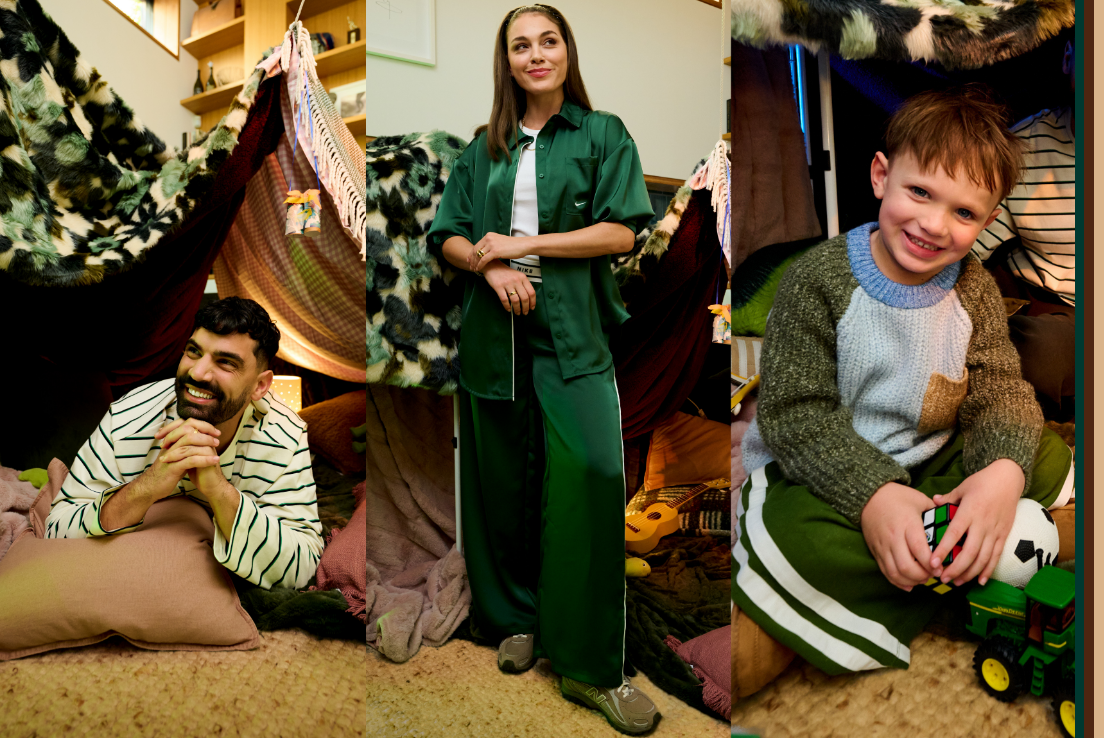 Three people wearing winter fashion styles pose inside a cosy blanket fort setting featuring layered textures soft furnishings and playful family-inspired moments.