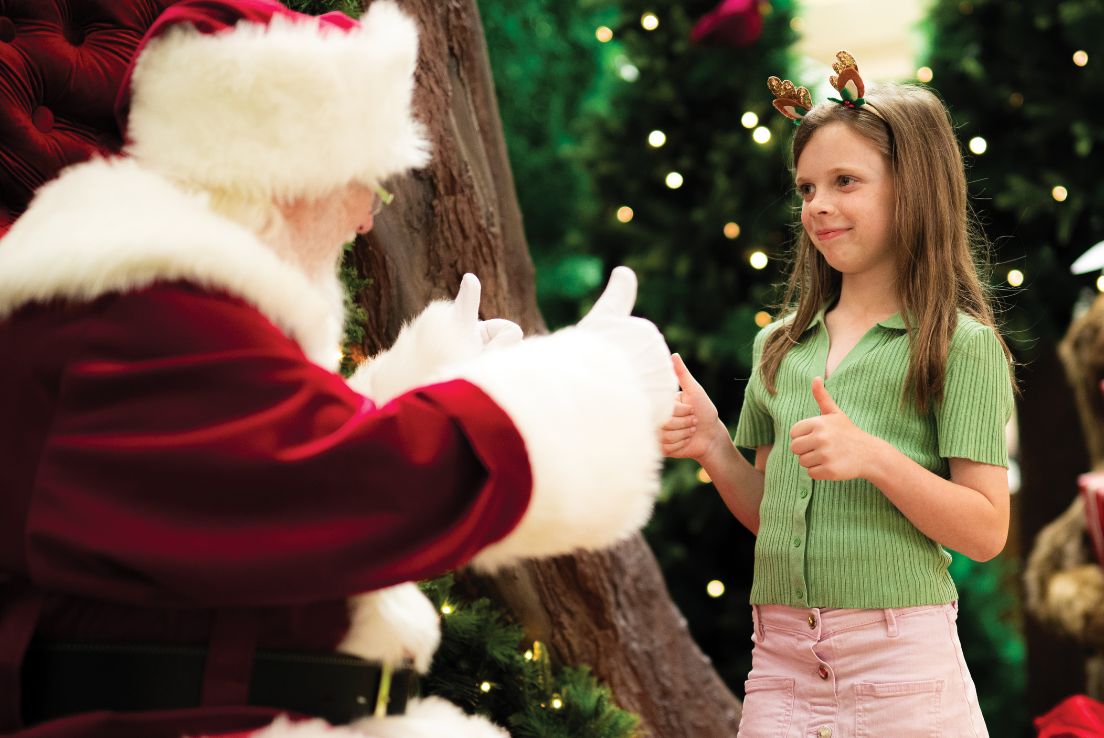 Santa and child signing thumbs-up