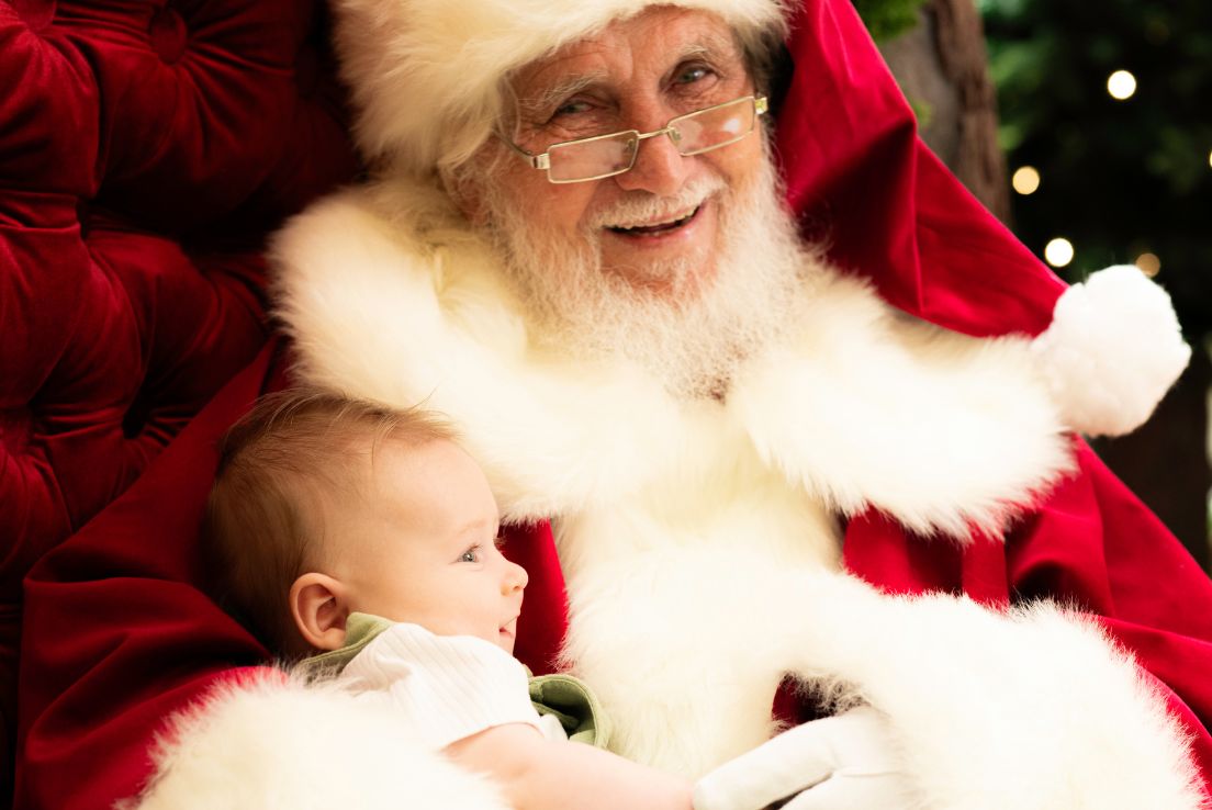 Baby cradled in Santa's arms