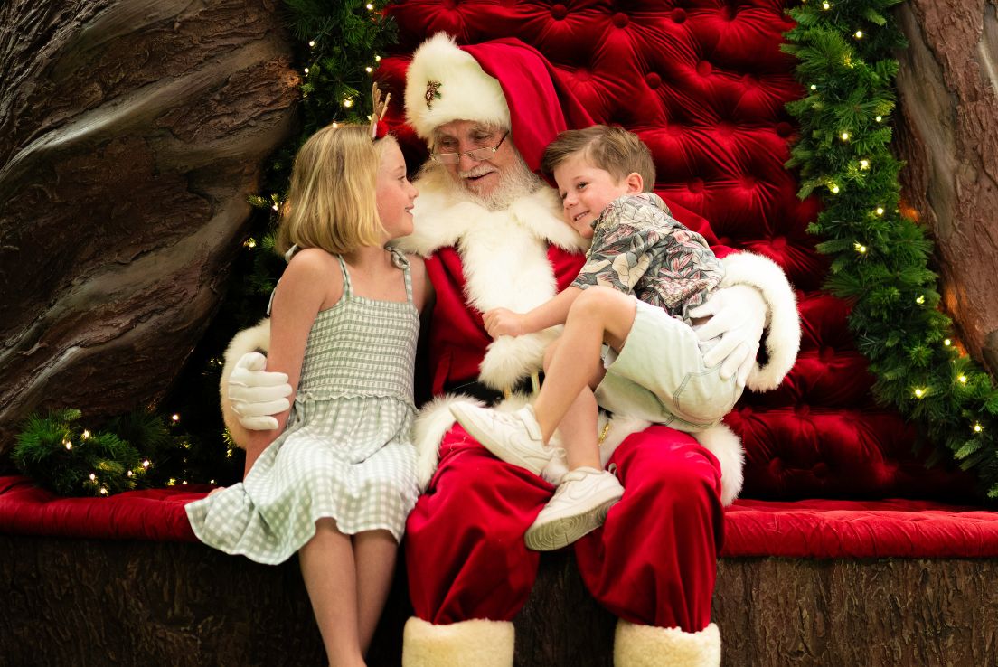 Santa on throne with two children