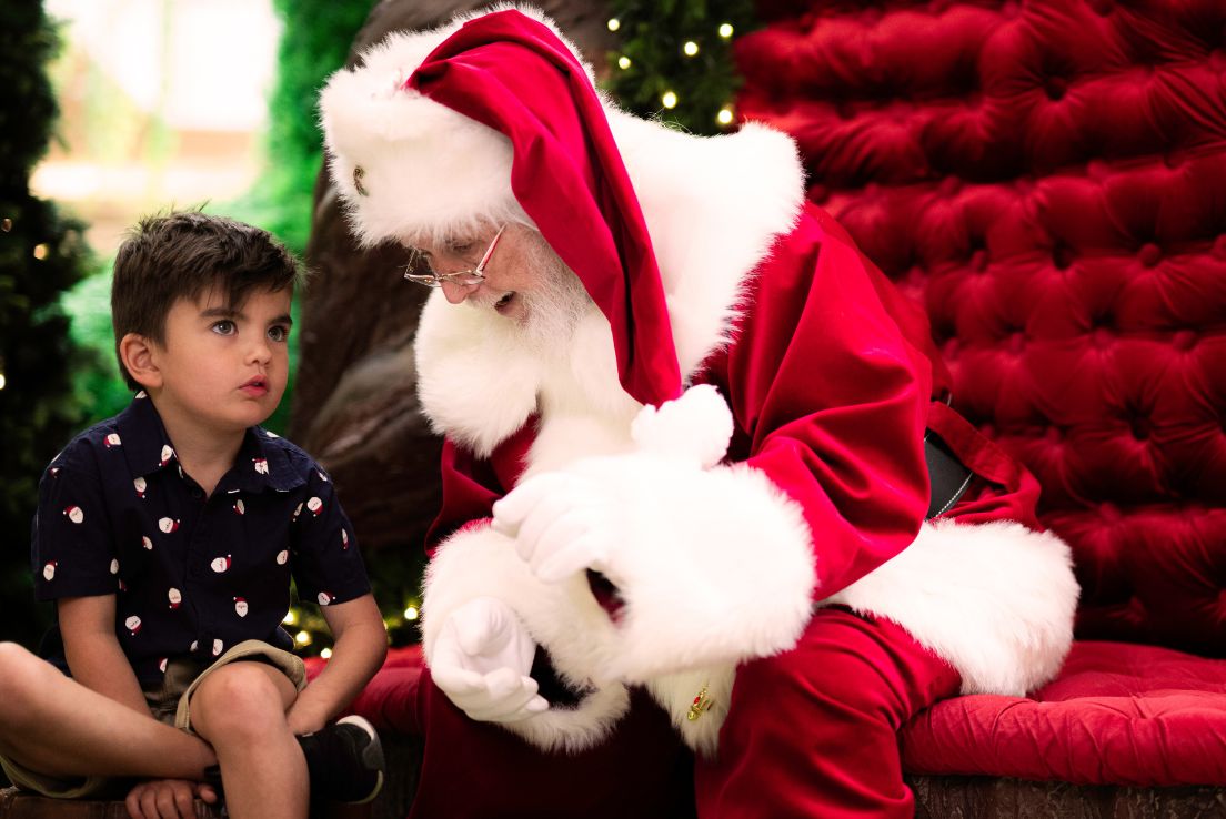 Santa gesturing to a seated child