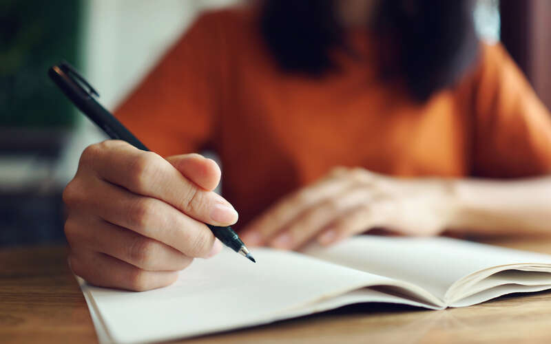 Woman writing in notebook