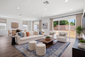 great room with neutral floors and large windows