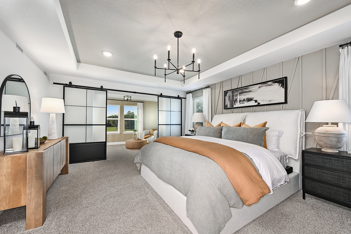 primary bedroom with carpet and white bed
