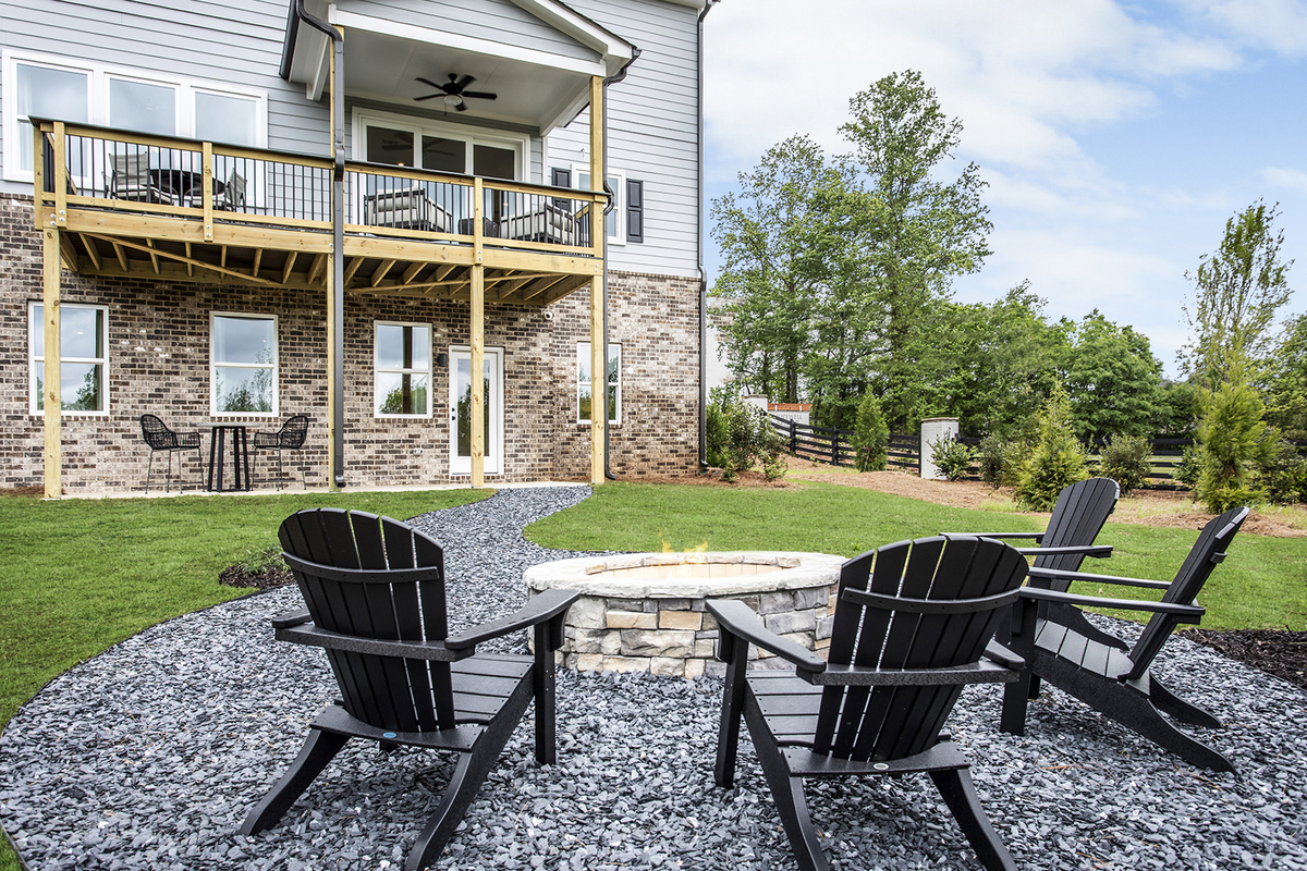 backyard with outdoor fireplace & patio table