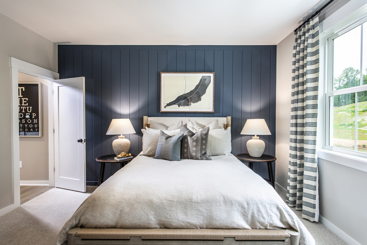 secondary bedroom with windows and carpet
