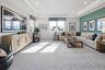 bonus room with tray ceiling and large windows